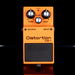 Orange distortion pedal with 'Boss' branding on a black background
