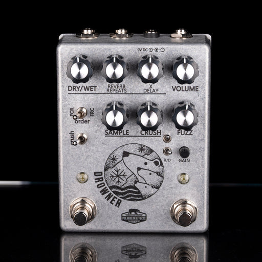 Guitar effects pedal with various knobs and switches on a black background