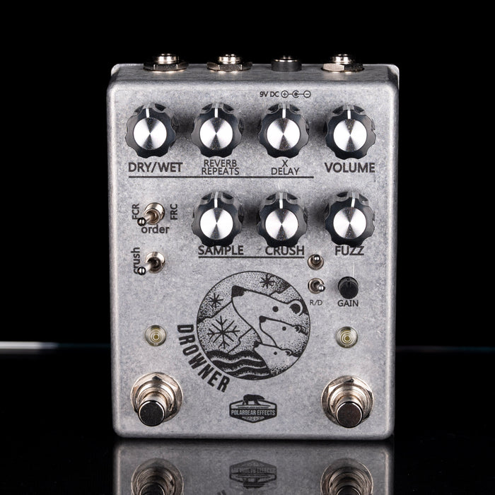 Guitar effects pedal with various knobs and switches on a black background