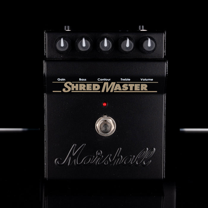 Marshall Shred Master guitar effects pedal with control knobs on a black background