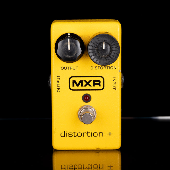 Yellow MXR guitar effects pedal with two knobs and a footswitch on a black background