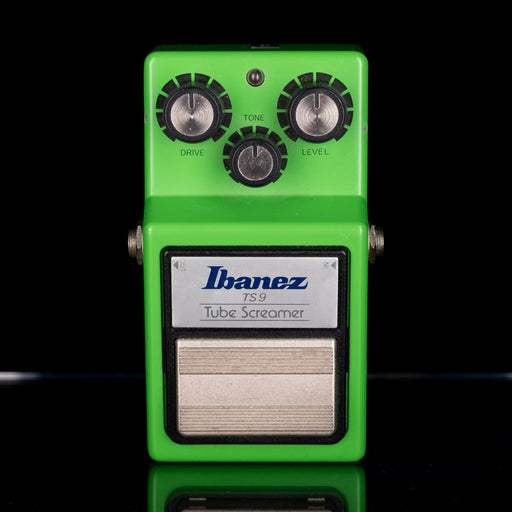 Green Ibanez TS9 Tube Screamer guitar effects pedal on a black background