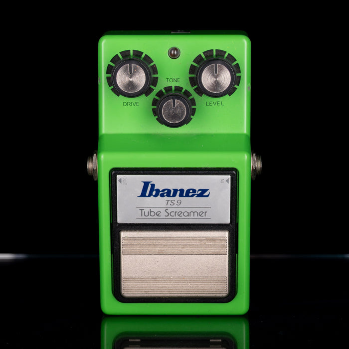 Green Ibanez TS9 Tube Screamer guitar effects pedal on a black background