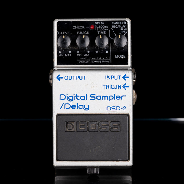 Boss digital sampler and delay pedal on a black background