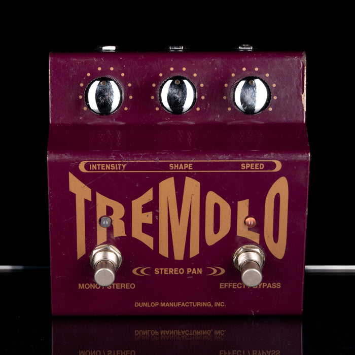 Purple guitar effects pedal with 'Tremolo' branding on a black background