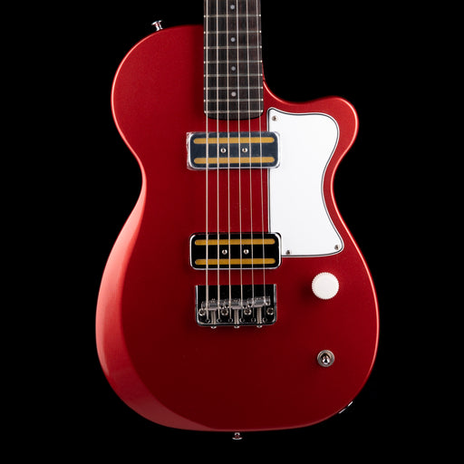 Red electric guitar with a white pickguard on a black background