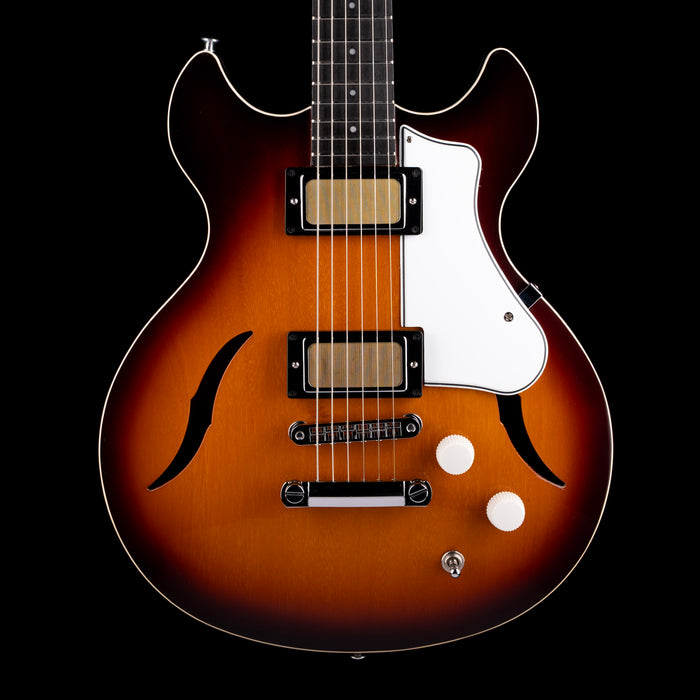 Electric guitar with a sunburst finish on a black background