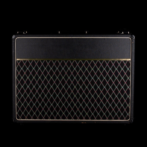 Black guitar amplifier with diamond pattern on a black background