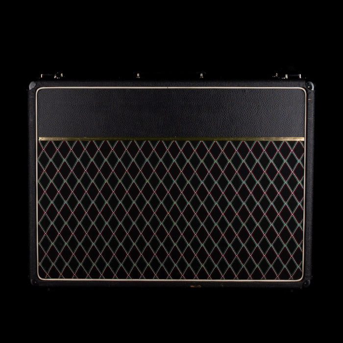 Black guitar amplifier with diamond pattern on a black background