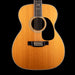 Acoustic guitar with a natural wood finish on a black background