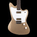 Beige electric guitar with a white pickguard on a black background