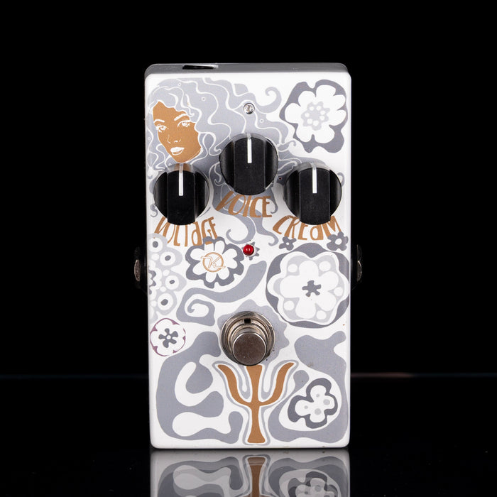 Guitar effects pedal with floral design on a black background