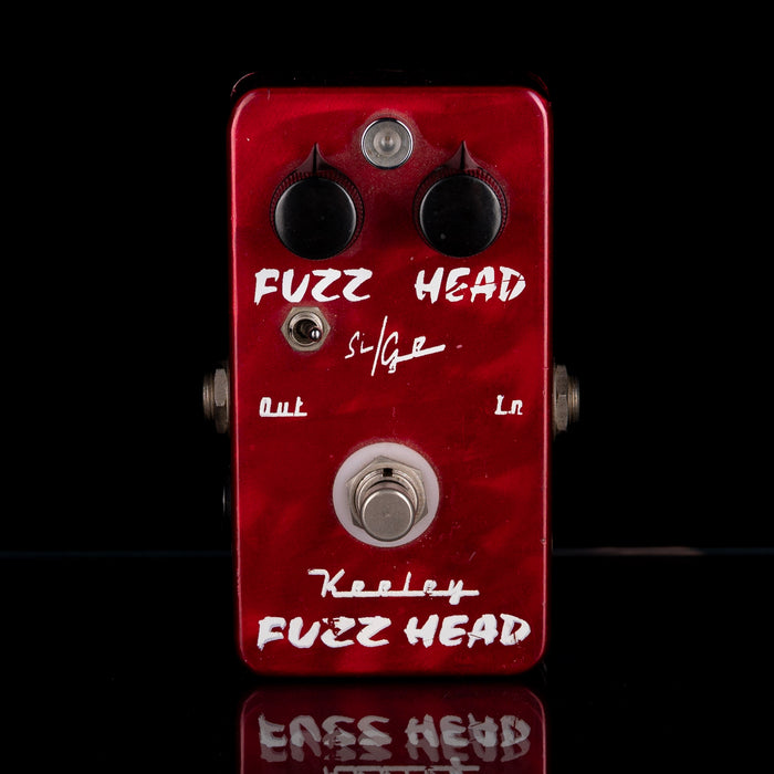 Red Keeley Fuzz Head guitar effects pedal on a black background