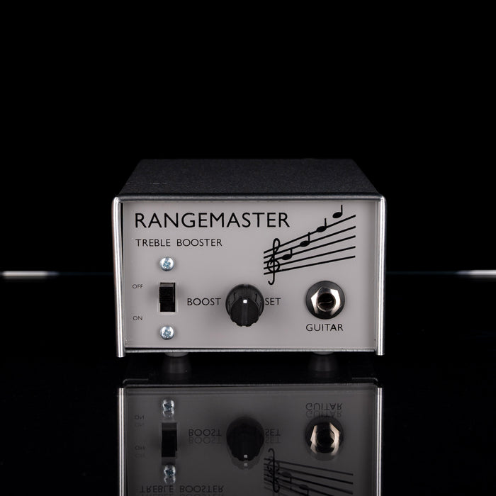 Rangemaster treble booster guitar effect pedal on a reflective surface with a black background