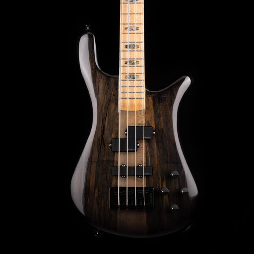 Bass guitar with a dark wood finish on a black background