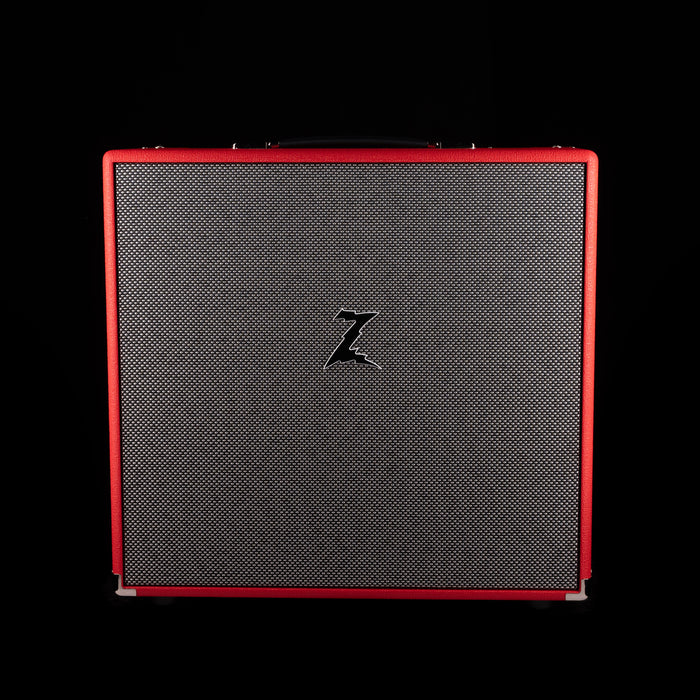 Black guitar amplifier cabinet with red trim on a black background
