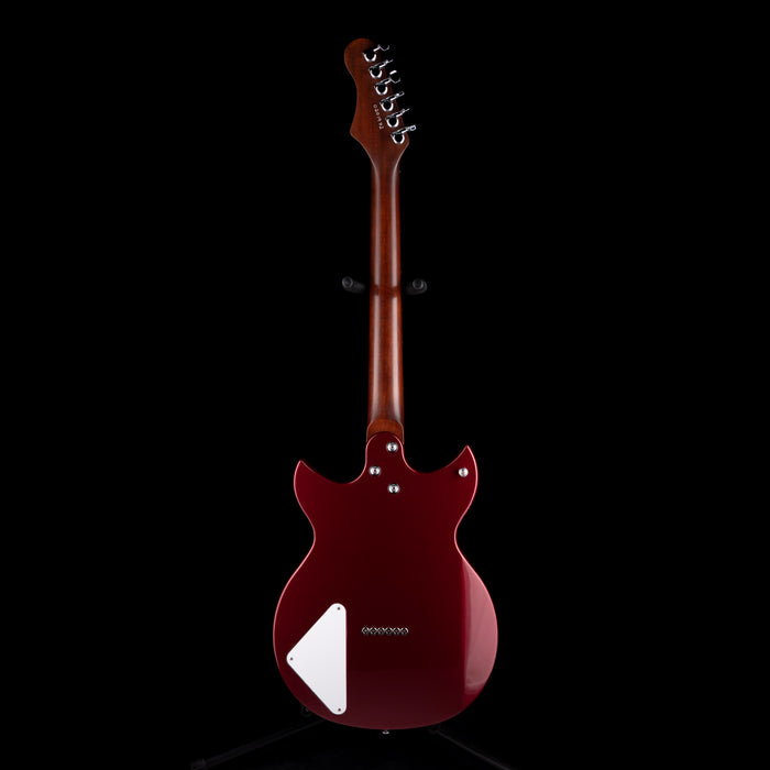 Guitar with a maroon body and white pickguard on a black background