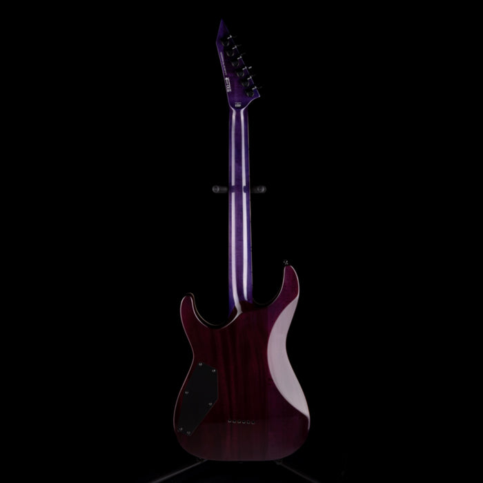 Electric guitar with a dark purple finish on a black background