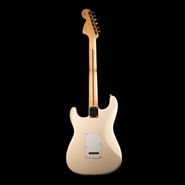 White electric guitar on a black background