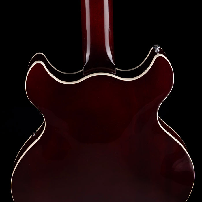 Close-up of a guitar's back on a black background