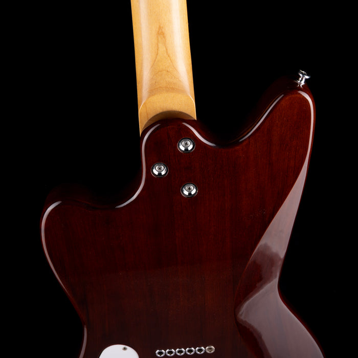 Close-up of a guitar's neck and headstock on a black background