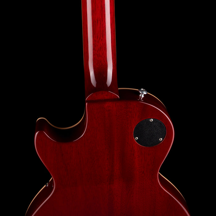 Close-up of a red electric guitar on a black background