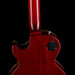 Close-up of a red electric guitar on a black background