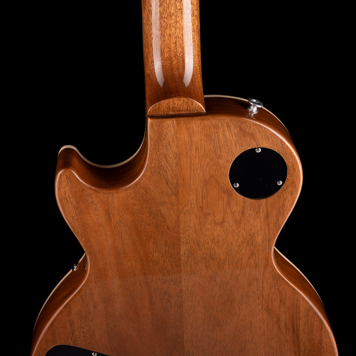 Close-up of a wooden guitar body with a black background