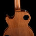 Close-up of a wooden guitar body with a black background