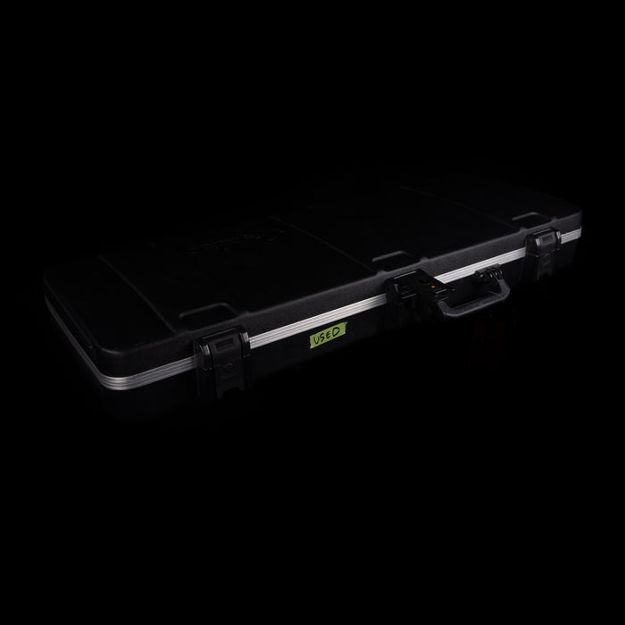 Black hard-shell case with a visible brand logo on a black background