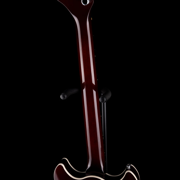 Close-up of a guitar neck and headstock on a black background