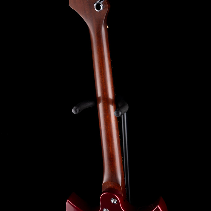 Close-up of a violin's back and neck on a black background
