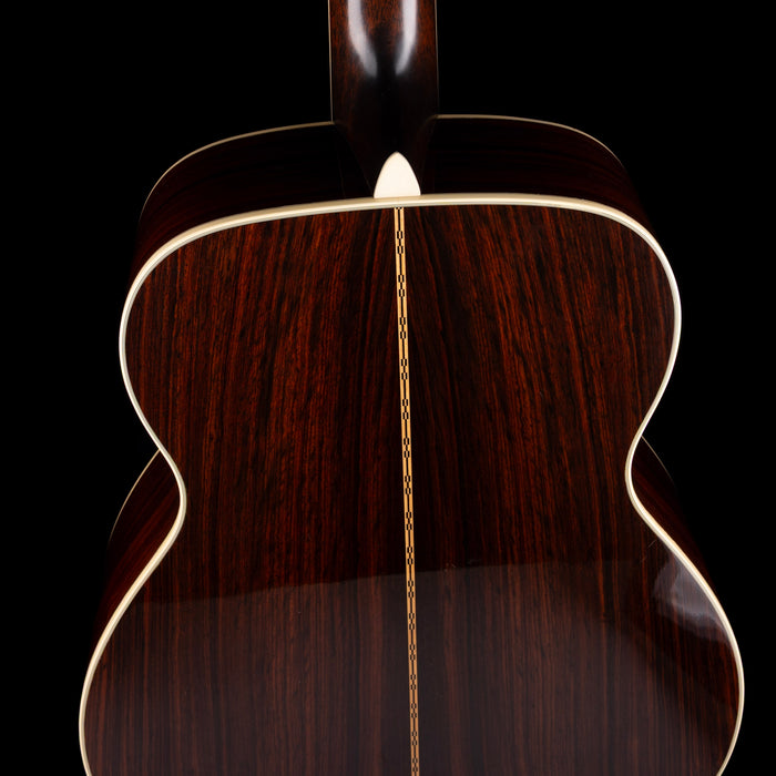 Close-up of a wooden acoustic guitar's soundhole on a black background