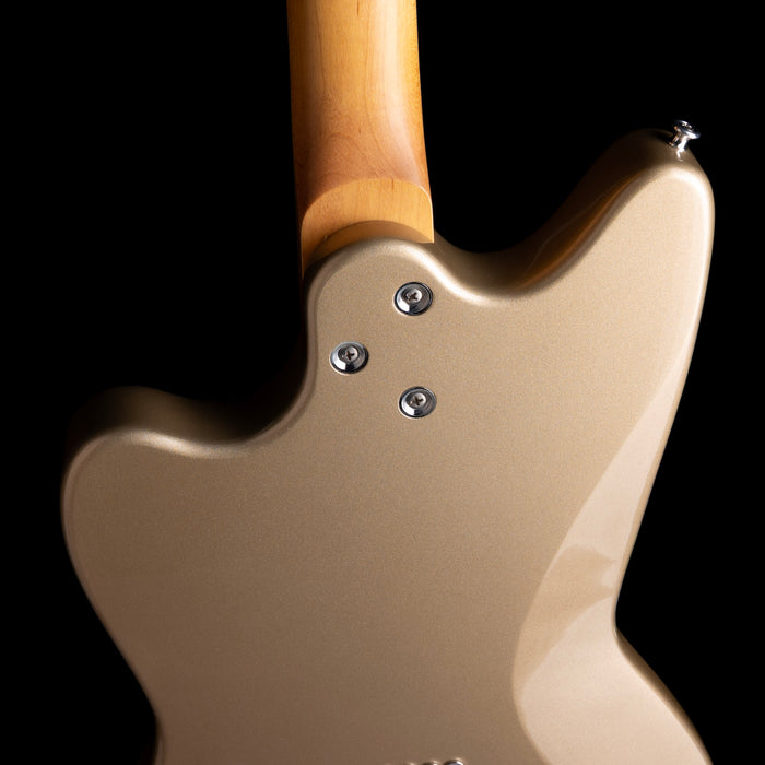 Close-up of a beige electric guitar with a wooden neck on a black background