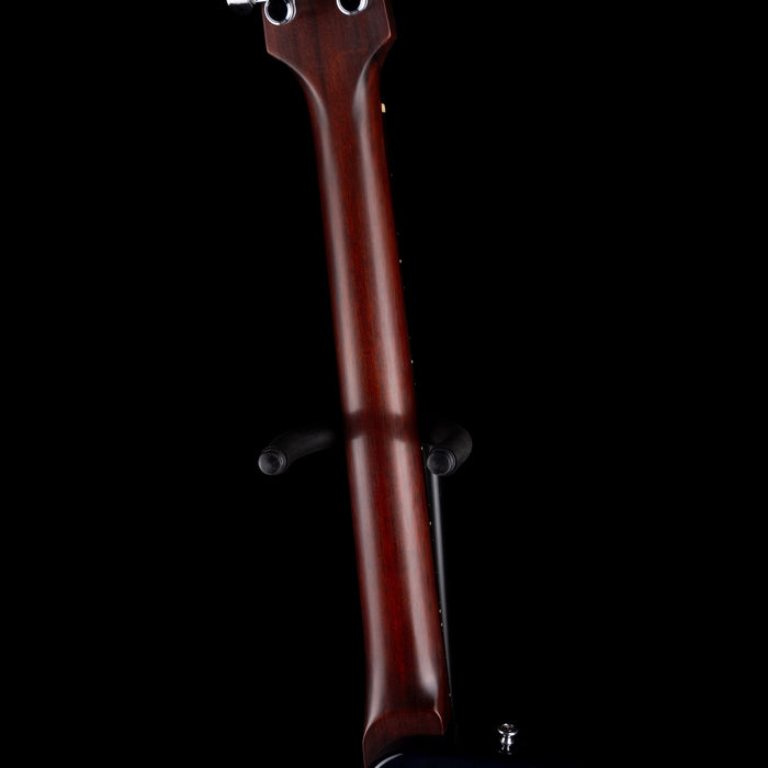 Close-up of a guitar neck with a dark background