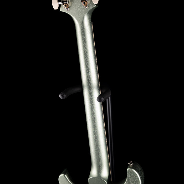 Close-up of a silver electric violin on a black background