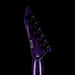 Purple electric guitar neck with tuning pegs on a black background