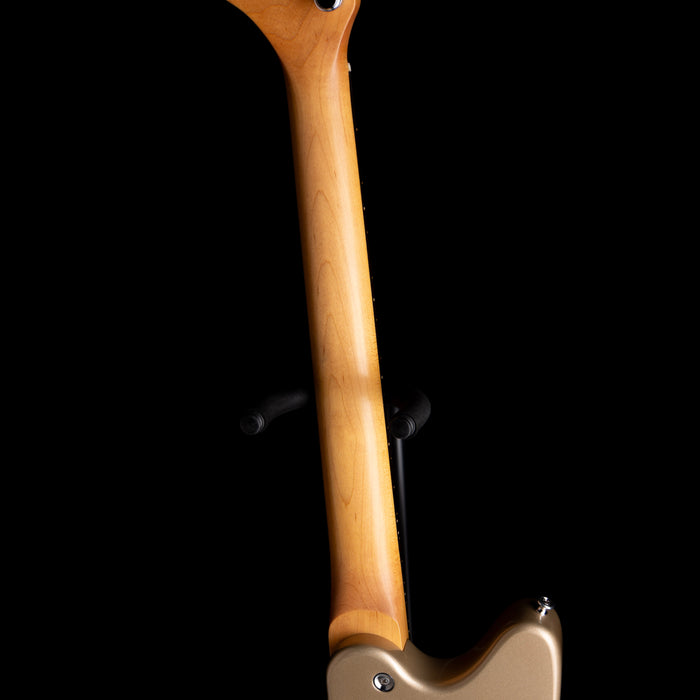 Close-up of a guitar neck with a wooden fretboard on a black background