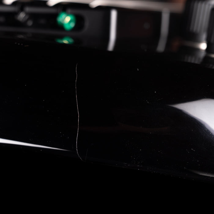 Close-up of a black car's side mirror with a blurred background