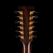 Close-up of a guitar's headstock with tuning pegs on a black background