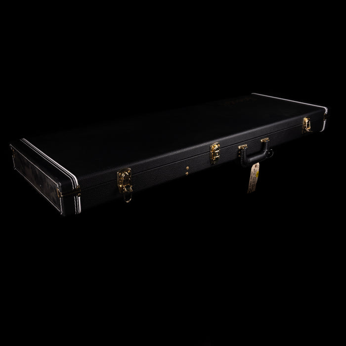 Black guitar case with gold latches on a black background