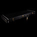 Black guitar case with gold latches on a black background