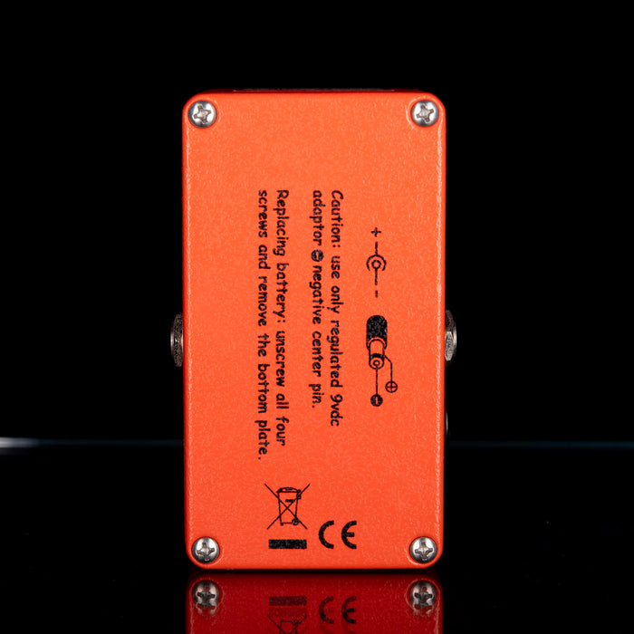 Orange electronic device with text and symbols on a black background