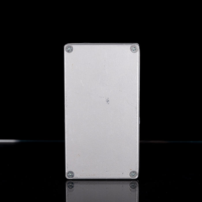 Metallic rectangular object with rounded edges on a black background