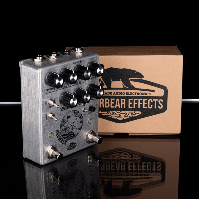Guitar effects pedal with 'Arbear Effects' branding on a reflective surface.