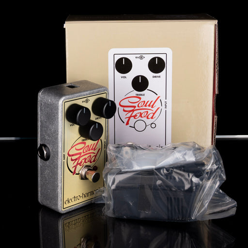 Guitar effects pedal with 'Soul Food' branding on a reflective surface.