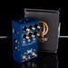 Blue guitar effects pedal with a black box featuring a brand logo on a reflective surface.
