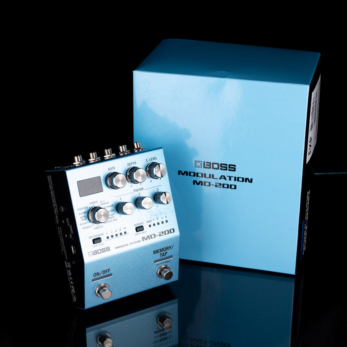 Boss MD-200 modulation effects pedal with its packaging on a reflective surface.