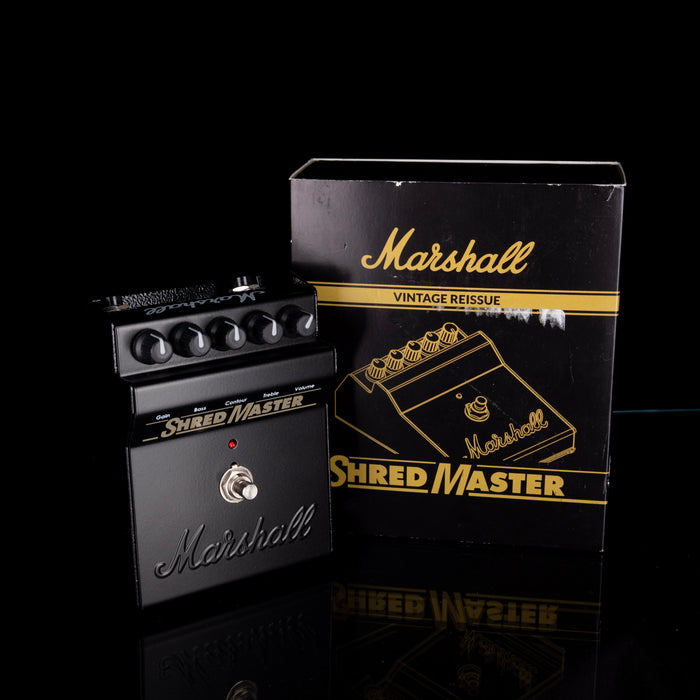 Marshall Shred Master guitar effects pedal with packaging on a black background