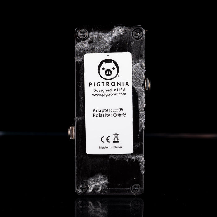 Pigtronix guitar effects pedal with a black background